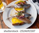 Traditional dish of Dutch cuisine is Haring, made from delicious herring with bread and decorated with radishes with fresh ..dill on top