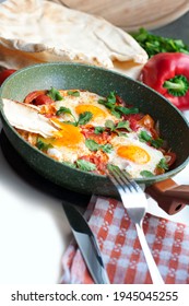 Traditional Dish Of Israeli Cuisine Shakshuka. Fried Eggs With Tomatoes, Peppers, Onions, Cilantro And Pita In A Pan On White Background