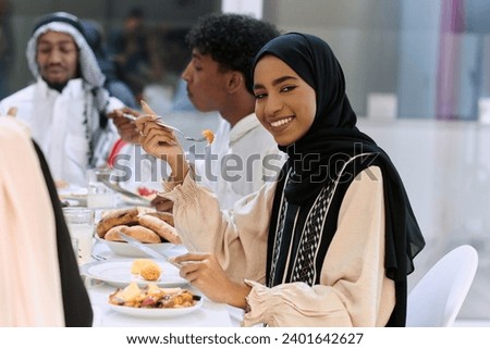 A traditional and diverse Muslim family comes together to share a delicious iftar meal during the sacred month of Ramadan, embodying the essence of familial joy, cultural richness, and spiritual unity