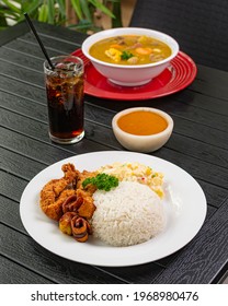 Traditional Dominican Meal, White Rice With Meat And Russian Salad, Sancocho And A Glass Of Soda.