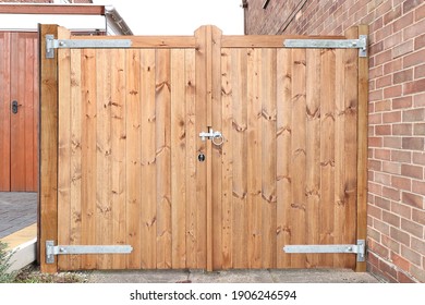Traditional double wooden gates with metal latch and hinges