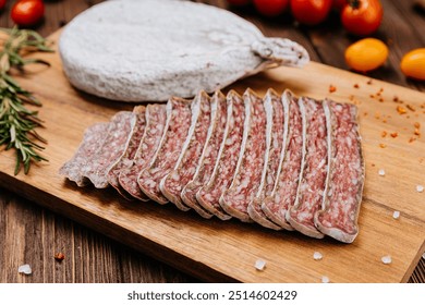 Traditional dry cured sausage slices on board with spices and herbs, perfect for food photography - Powered by Shutterstock