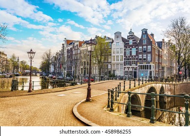 Traditional dutch old houses and bridges on canals in Amsterdam,  Netherlands