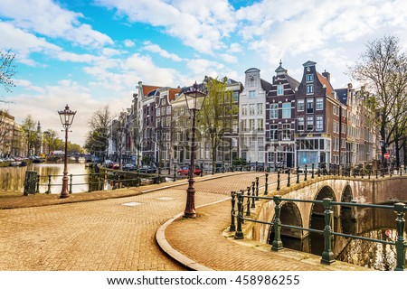 Traditional dutch old houses and bridges on canals in Amsterdam,  Netherlands