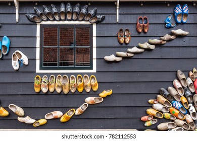 Traditional dutch shoes called clogs on a wooden house as decoration