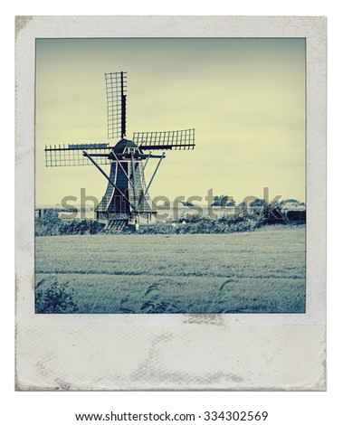 Traditional dutch windmill on the countryside in the netherlands edited with a vintage look 
