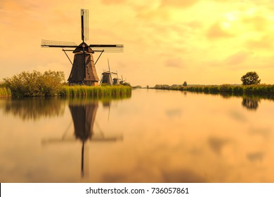 Traditional Dutch Windmills Kinderdijk, World Unesco heritage, on a sunny day late summer. Reflection visible on the water surface.