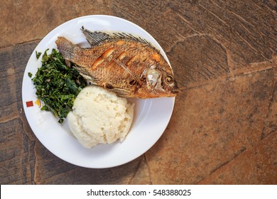 Traditional East African Food - Ugali, Fish And Greens