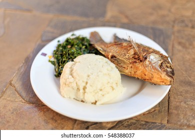 Traditional East African Food - Ugali, Fish And Greens