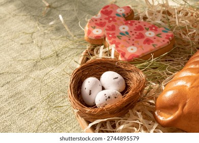 Traditional Easter bread with festive bunny cookie and decorative nest with eggs in rustic spring setting