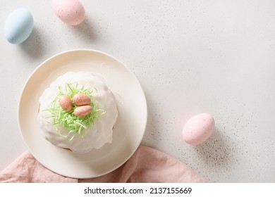 Traditional Easter cake and pink eggs on white background. Space for text. View from above.