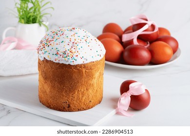 Traditional easter cake or sweet bread and eggs in white table. Easter treat, holiday symbol
