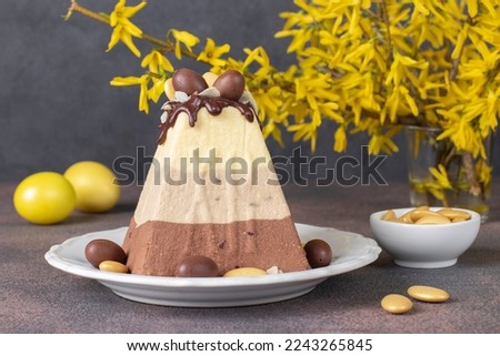 Traditional Easter cottage cheese dessert made of three types of chocolate - white, milk and dark, decorated with chocolate eggs