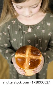 Traditional Easter Hot Cross Buns. Little Girl Holding Round Bread. Hands Holding Big Bread.