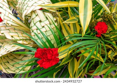 Traditional Ecuadorian decorative Palm Sunday bouquets made from palm leaves and carnations are sold at the Flower Market in Cuenca.