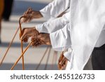 Traditional Emirati Al Ayalah male dance, UAE heritage, hands in frame. High quality photo.