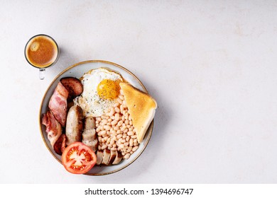 Traditional English Breakfast: Sausages, Toast Bread, Beans, Eggs, Tomatoes And Coffee In Frying Pan Over White Texture Background. Top View, Flat Lay