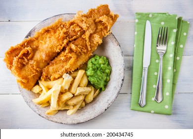 Traditional English Food - Fish And Chips With Mushy Peas