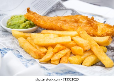 Traditional English Food such as Fish and Chips with mushy peas served in the Pub or Restaurant - Shutterstock ID 713321020