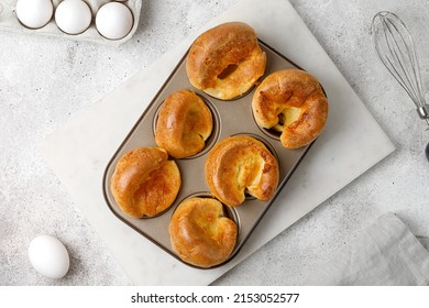 Traditional English Yorkshire Pudding In Baking Dish, In Muffin Cups. Homemade British Food. Grey Background. Top View