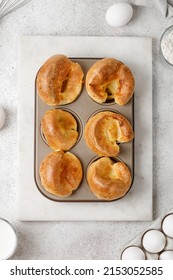 Traditional English Yorkshire Pudding In Baking Dish, In Muffin Cups. Homemade British Food. Grey Background. Top View