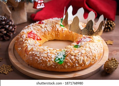 Traditional Epiphany cake Roscon de Reyes with crown on wooden table top closeup, top view