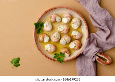 Traditional Escargot With Garlic Butter In A Dish On A Stone Background. Selective Focus.