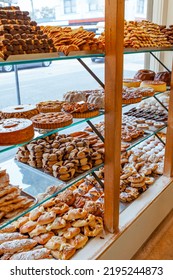 Traditional European Bakery Shop Interior, Cake Pastry And Bread Window Display, Pie, �clair, Citrus Cake, Chocolate Biscuit Cookie, Almond Bread