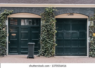 Traditional european garage with black brick and dark gates
