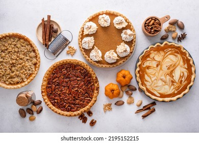 Traditional fall Thanksgiving pies variety, pumpkin, pecan and cheesecake pumpkin pie on light background - Powered by Shutterstock