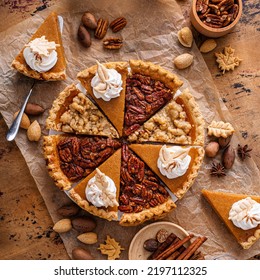 Traditional Fall Thanksgiving Pies Variety Of Slices Arranged Into Circle, Pumpkin Crumb And Pecan Pie Overhead On A Rustic Wooden Table