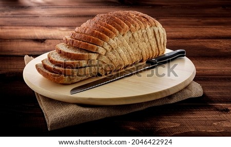 Traditional Farmhouse Whole Wheat Sliced Bread on Dark Wooden isolated  Background