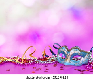 Traditional female carnival venetian mask  on table .Masquerade  mask on  glitter background.Mardi Gras.