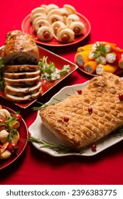 Traditional festive Christmas dishes on the table. Wellington with mushrooms, stuffed turkey roll, stuffed peppers - Shutterstock ID 2396383775
