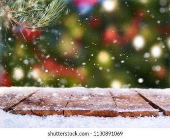 Traditional festive Christmas tree light decoration background with a snow covered wooden table top. - Powered by Shutterstock