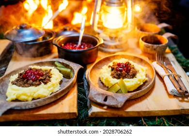 Traditional Finnish Food Sauteed Reindeer With Mashed Potatoes And Lingonberries Served In Lappish Hut Next To Open Fire