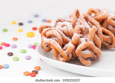 Traditional Finnish May Day Funnel Cake (tippaleipa) On The White Plate With Colorful Small Candies. Close Up.