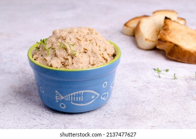 Traditional fish pate in a ceramic dish on a light background. Selective focus.