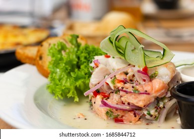 Traditional Fish And Shrimp Ceviche With Onion With Zucchini On Top. Delicious Raw Plate From Peru Decorated With Green Vegetables. Healthy Eating, Gourmet Restaurant Concepts