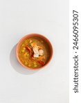 Traditional Fish Soup with Two Types of Fish in Clay Bowl on White Background.