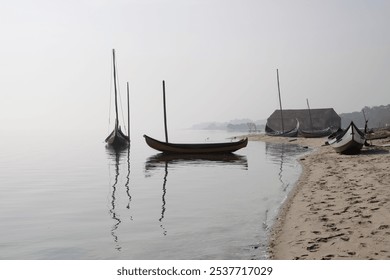 Traditional fisherman wooden boats from Ria de Aveiro, Portugal, in a foggy morning. - Powered by Shutterstock