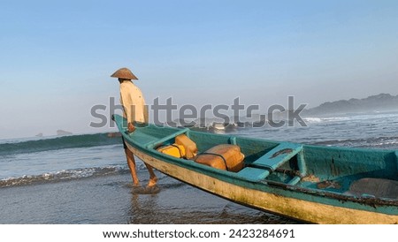 Traditional fishermen take their boats to fish in the Java Sea.