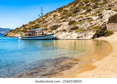 Traditional fishing boat anchoring in Maltezi bay with amazing beach, Amorgos island, Cyclades, Greece - Powered by Shutterstock