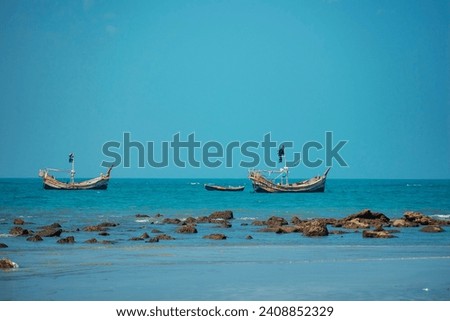 Traditional Fishing Boat Bobs on Serene Waters off Bangladesh Coast in St. Martin Island, Bangladesh