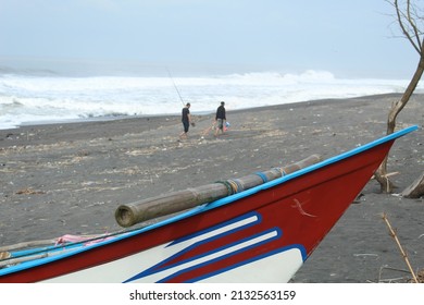 Traditional Fishing Boat Cutout With Fisherman Background On The Beach With Big Waves During The Day. Photo Is Noise