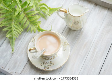 Traditional Five O'clock English Tea In An Elegant China Set. Cup Of Tea With Milk And Milk Jug On A Wooden Tray. Top View.