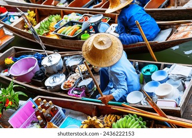 Traditional floating market in Damnoen Saduak near Bangkok, Thailand. Vendors on Damnoen Saduak Floating Market, Bangkok in Thailand - Powered by Shutterstock