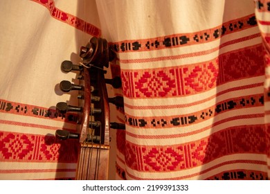 Traditional Folk Music Instrument Standing On The Background Of Traditional Ukrainian Embroidery