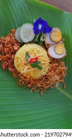 Traditional Food From Indonesia Yellow Rice And Side Dishes, Spicy Eggs, Fried Noodles And Spicy Tempe