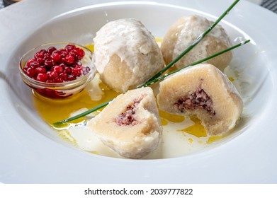 Traditional food on Swedish Baltic Sea island Öland. Kroppkaka is a traditional boiled potato dumpling filled with minced pork and onion and often served with cream and lingon berries.